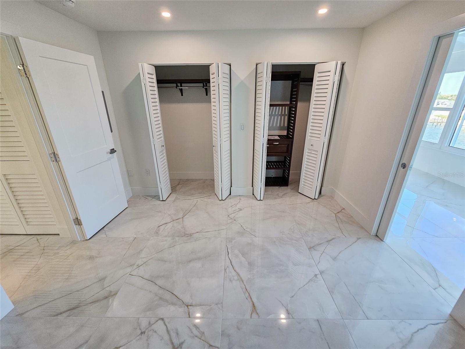 Primary Bedroom w/ Custom Built-in Double Closets.