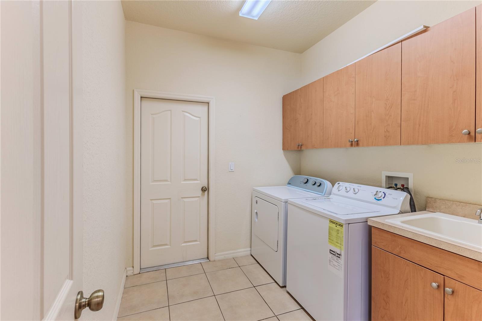 Laundry Room with Utility Sink, Cabinets + Washer & Dryer