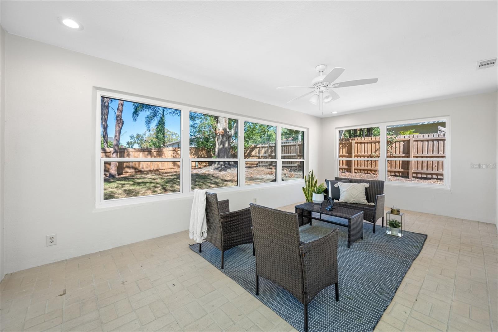 Florida room located off of the family room has brick paver flooring in a neutral palette.  The space has central heating and air-conditioning and provides a relaxing setting to enjoy views of the private back yard