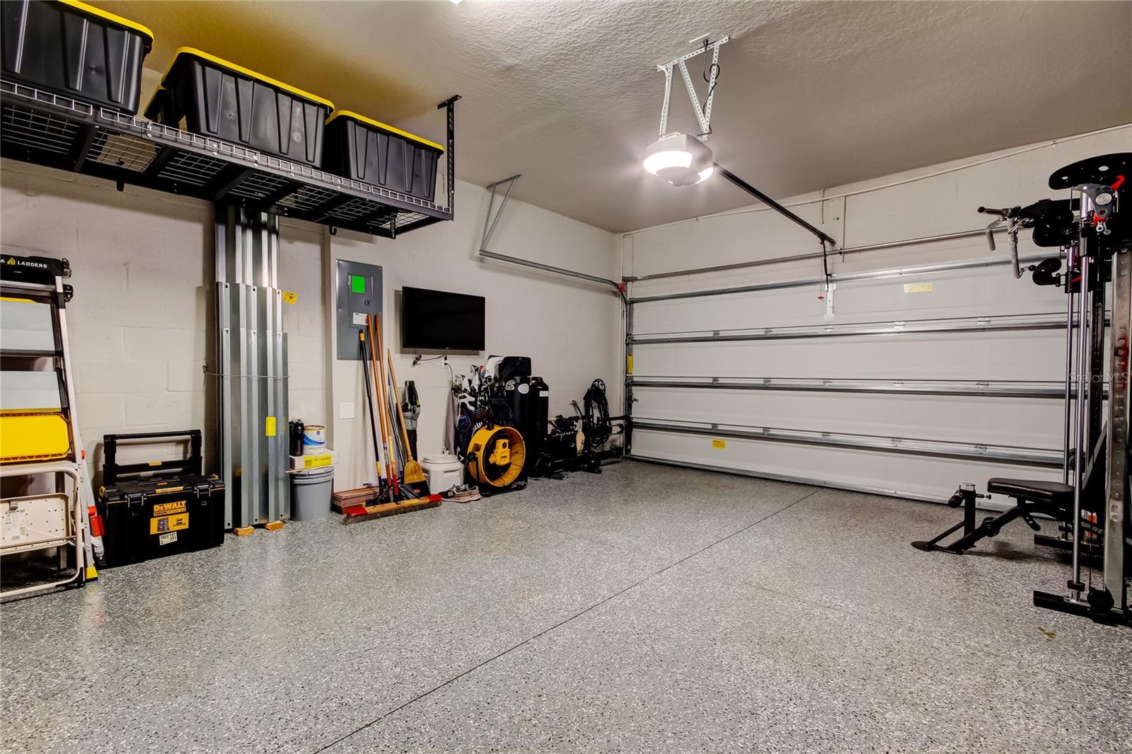 The garage is outfitted with a Husky cabinet system and ceiling-mounted storage racks.