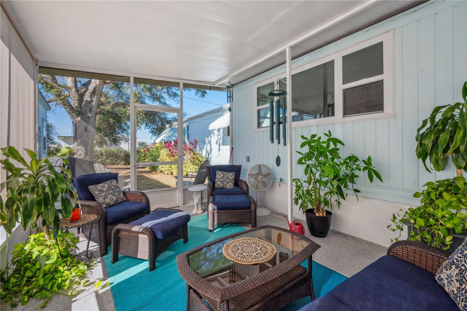 Magical area of tranquility in this screen room overlooking backyard gardens.