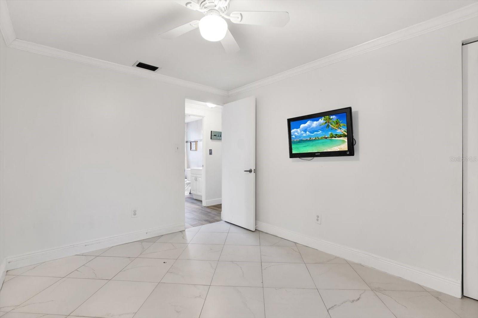 Guest Bedroom - Closet extends length of wall behind television.