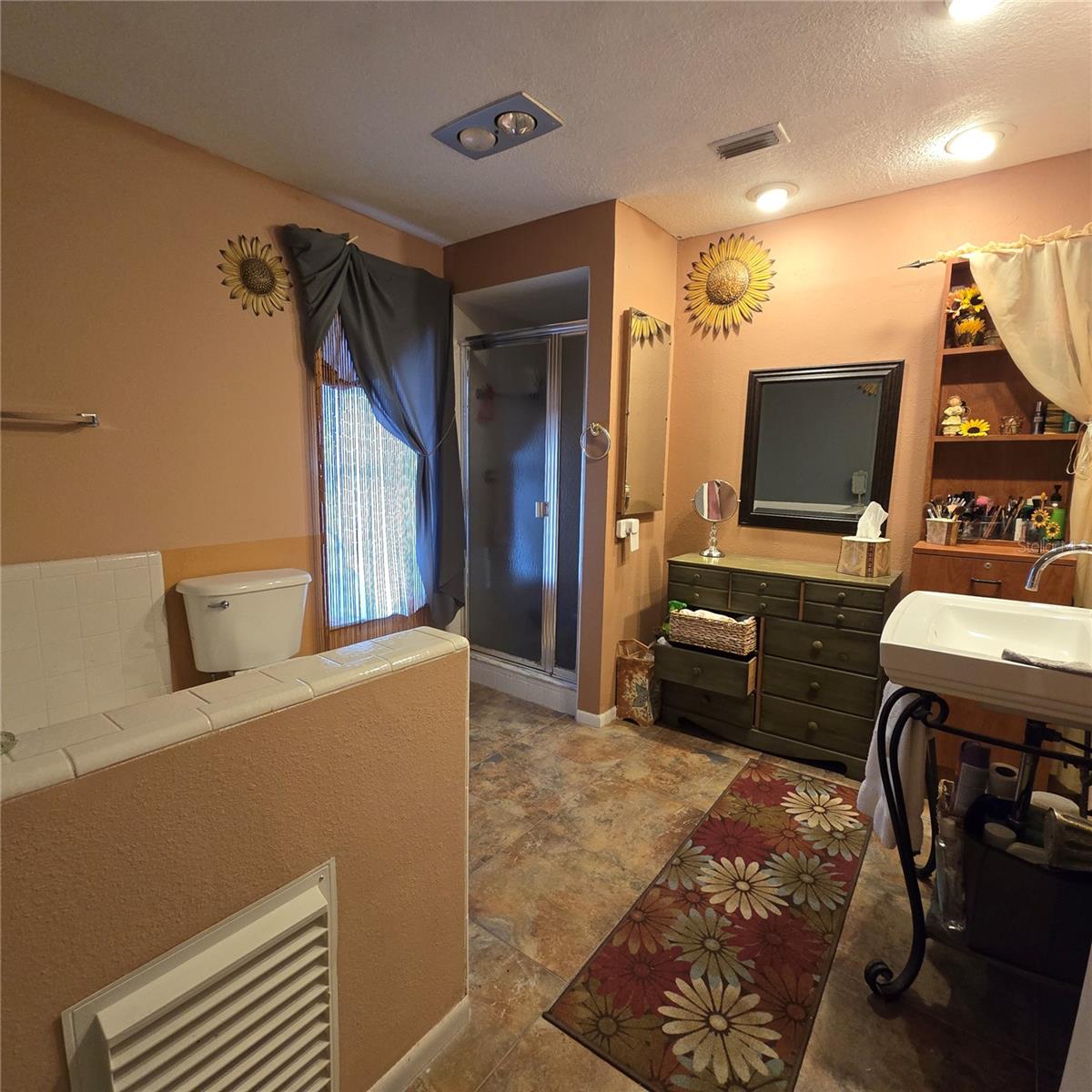 Primary bathroom with separate shower stall and tub