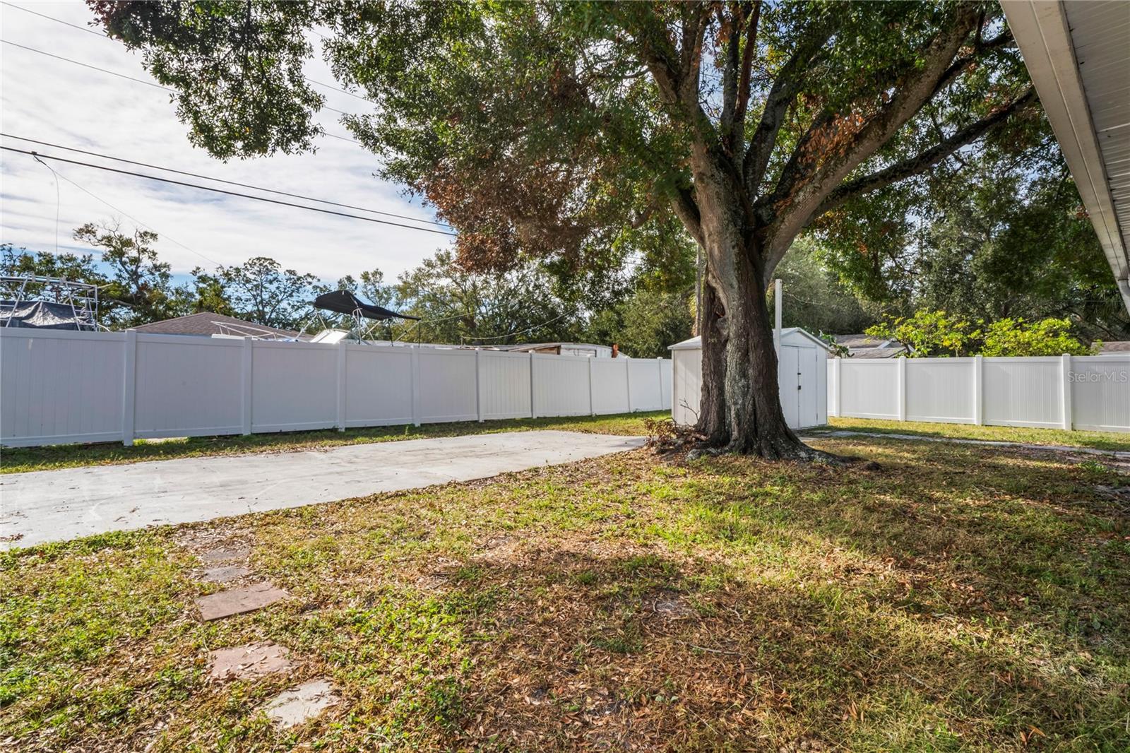 Fenced Backyard with concrete deck