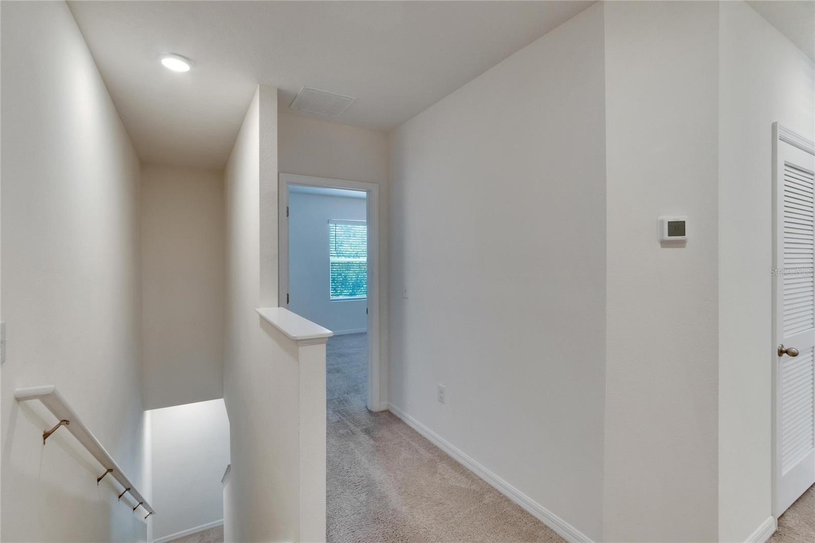 Top of Stairs Looking Into the Primary (Master) Bedroom