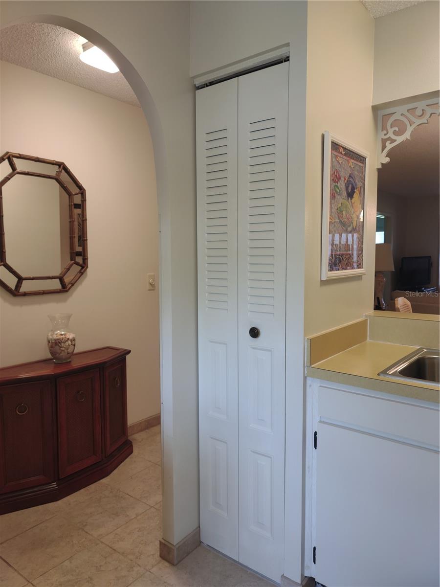 Arched kitchen doorway to main entry.