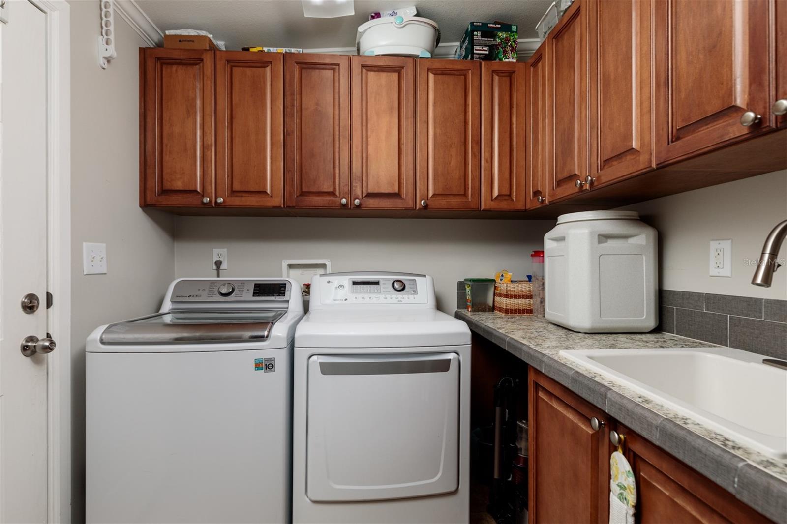 inside laundry room with sink and cabinets