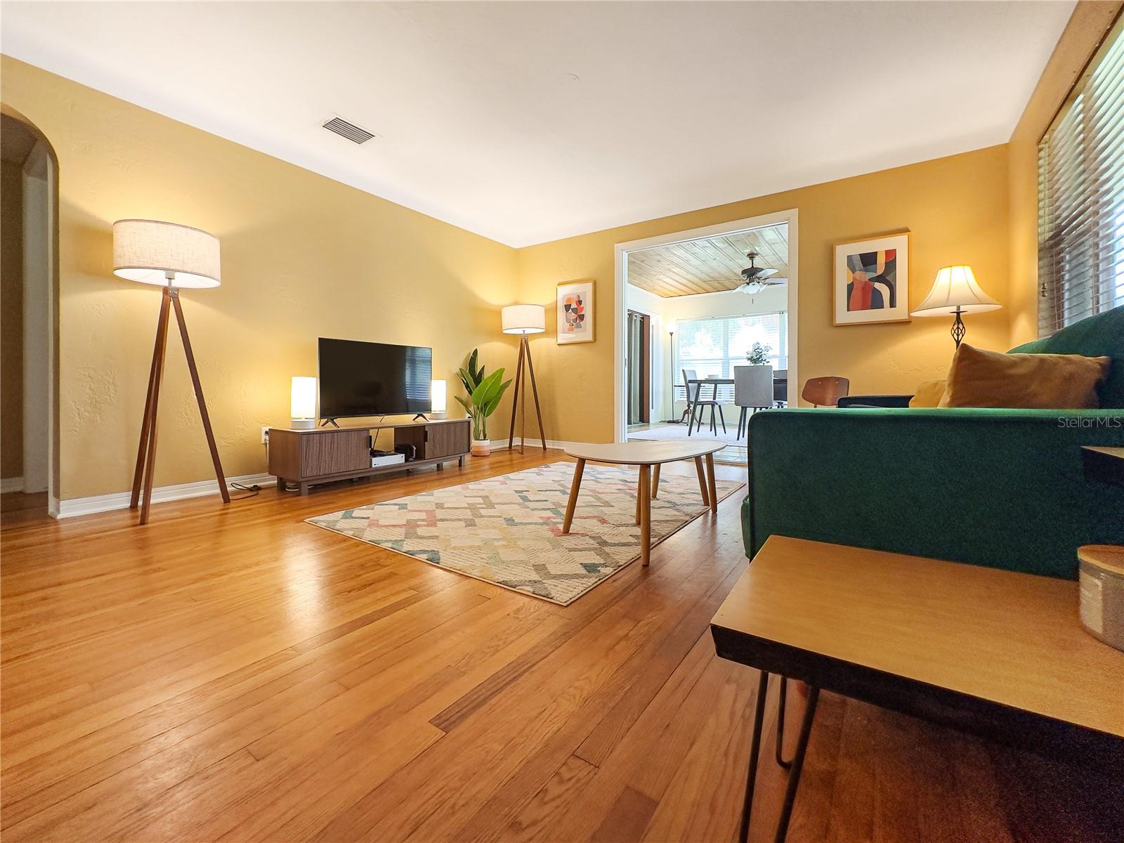 Family room with original oak hardwood flooring and coved plaster ceiling.