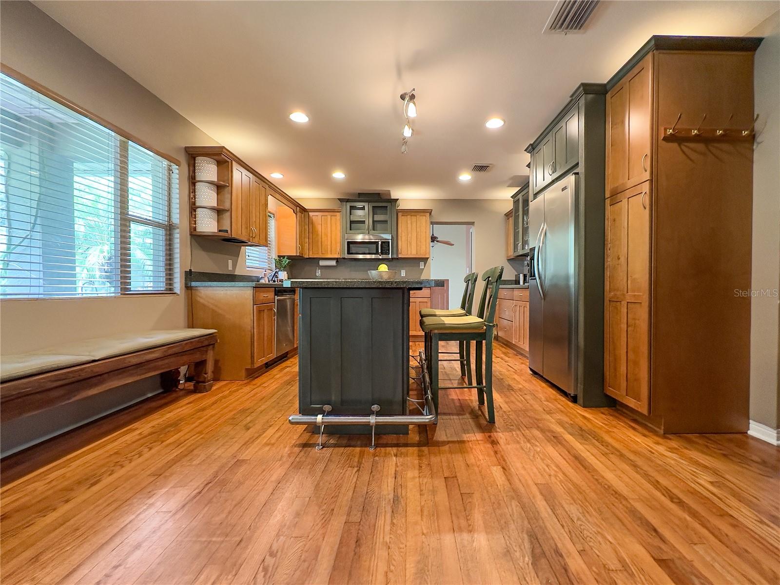 Updated kitchen with original hardwood oak flooring.