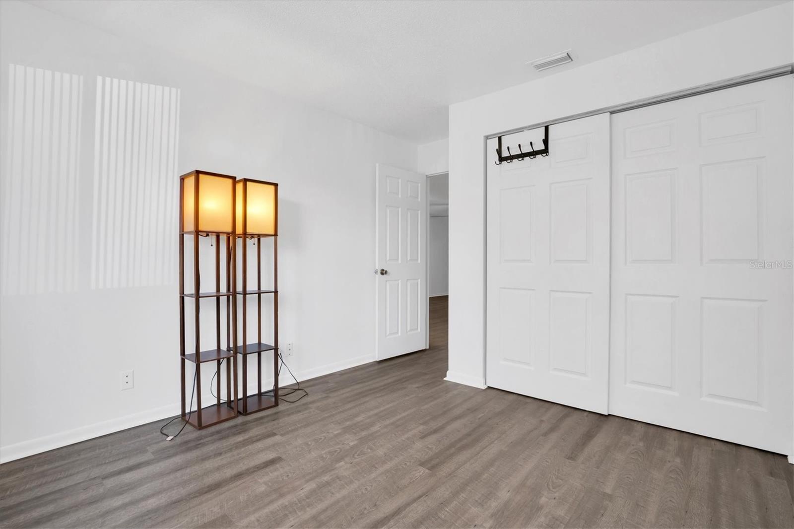 Front bedroom showing closet and hallway entry