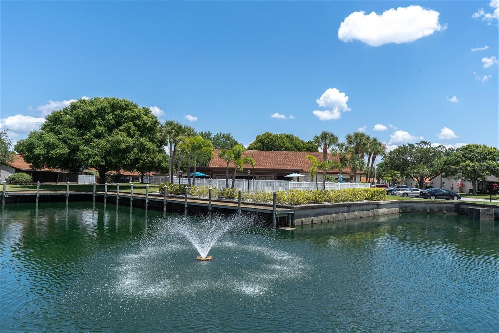 There's a pond at the center of the complex, with a small fountain. Looking over to large pool and clubhouse