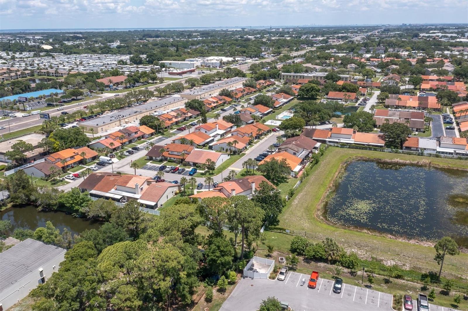 Red tile roofs are the Rosetree Village community. The road going through to the top at upper left, just under the blue pond is Ulmerton Road, a central thoroughfare through Pinellas County. Convenient location