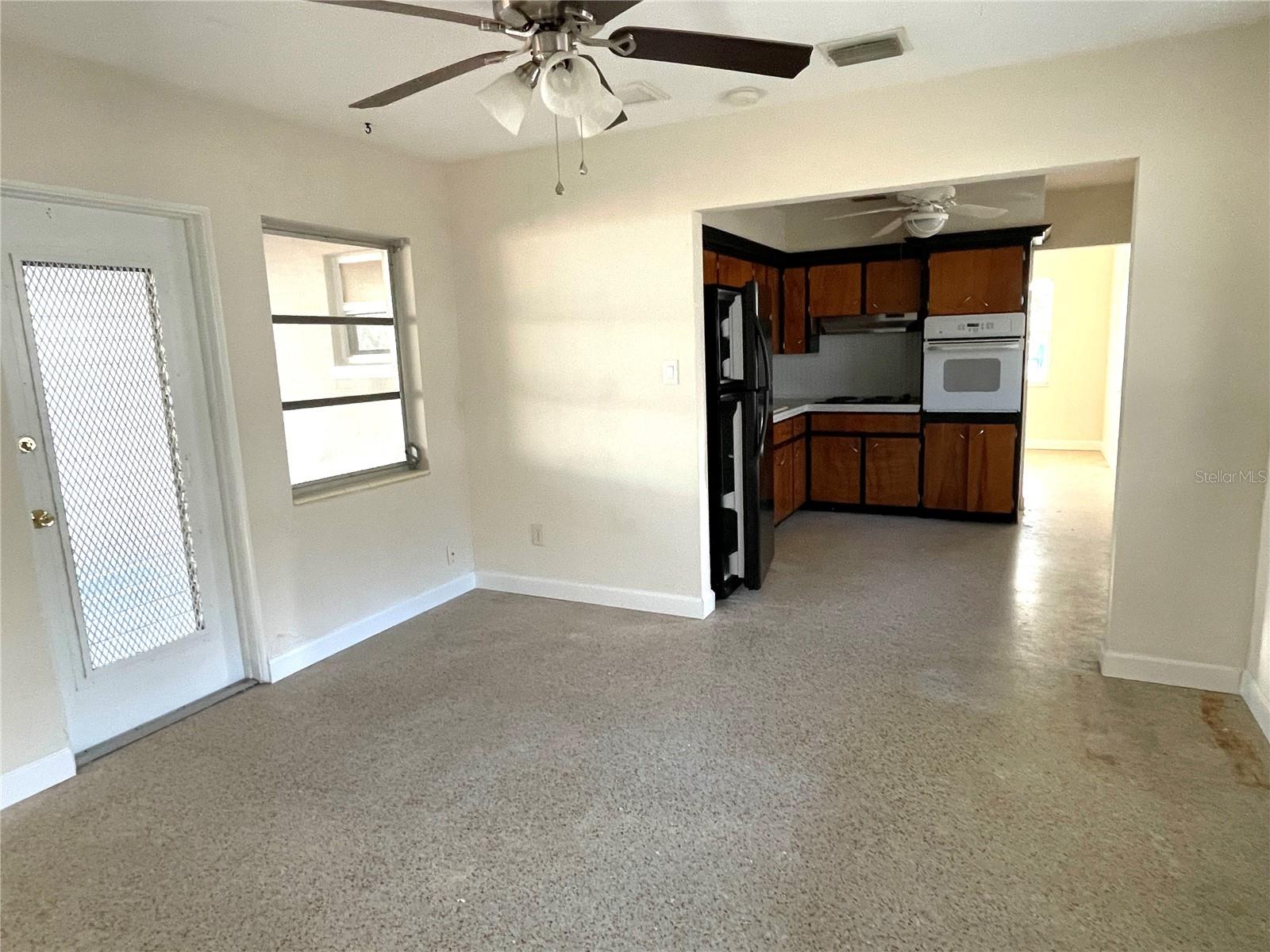 Looking through family room toward kitchen & living room beyond.