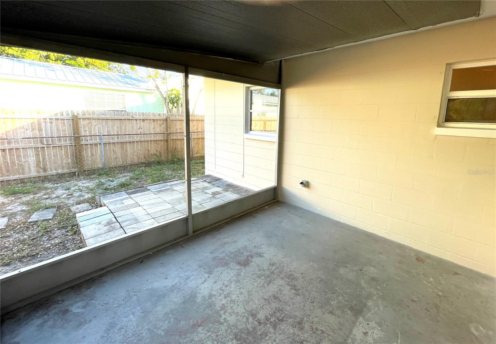 Shady roofed patio w/new screening, adjacent to the family room. Open patio beyond.