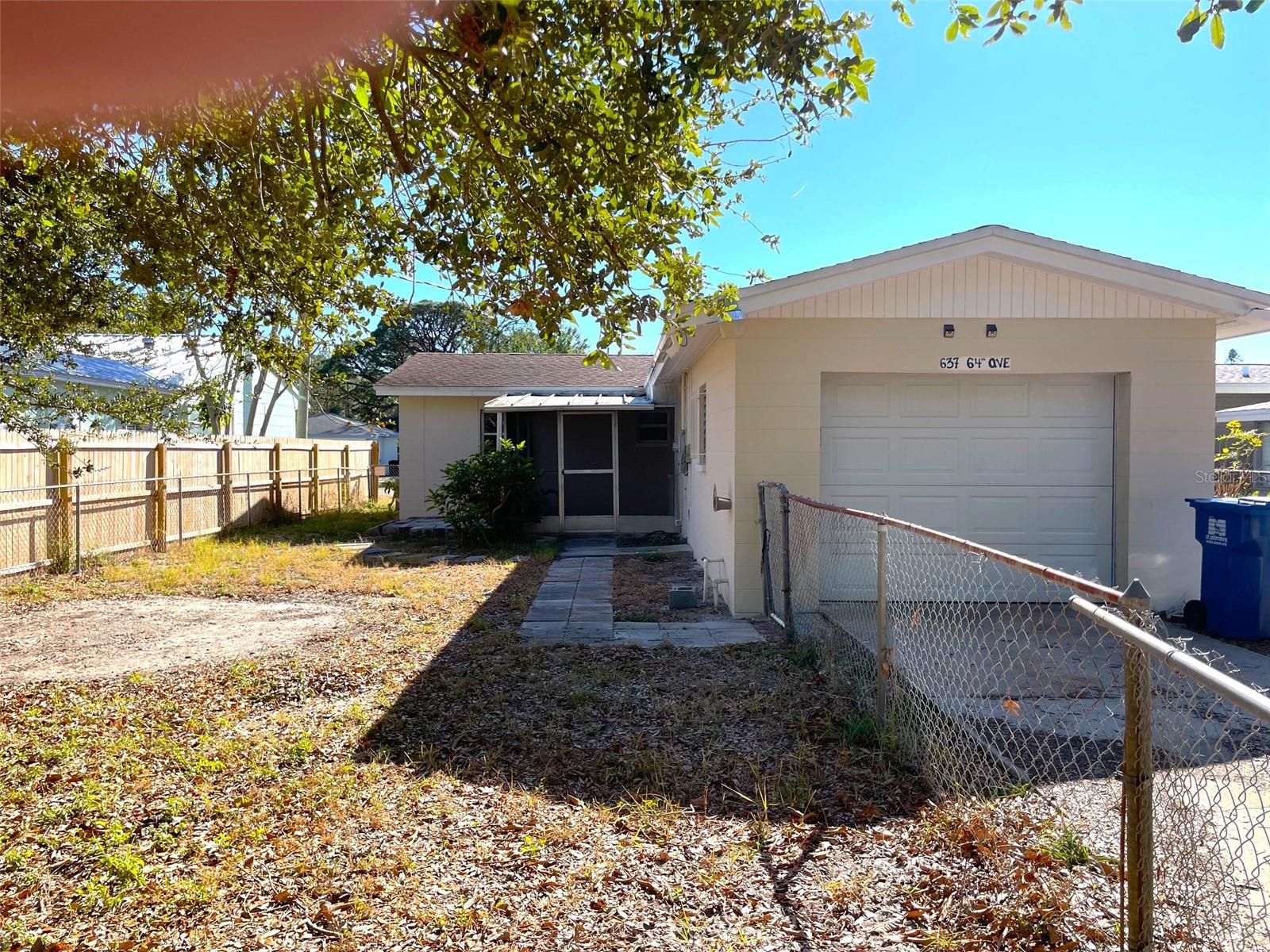 View of garage and fenced side/rear yard from the alley.