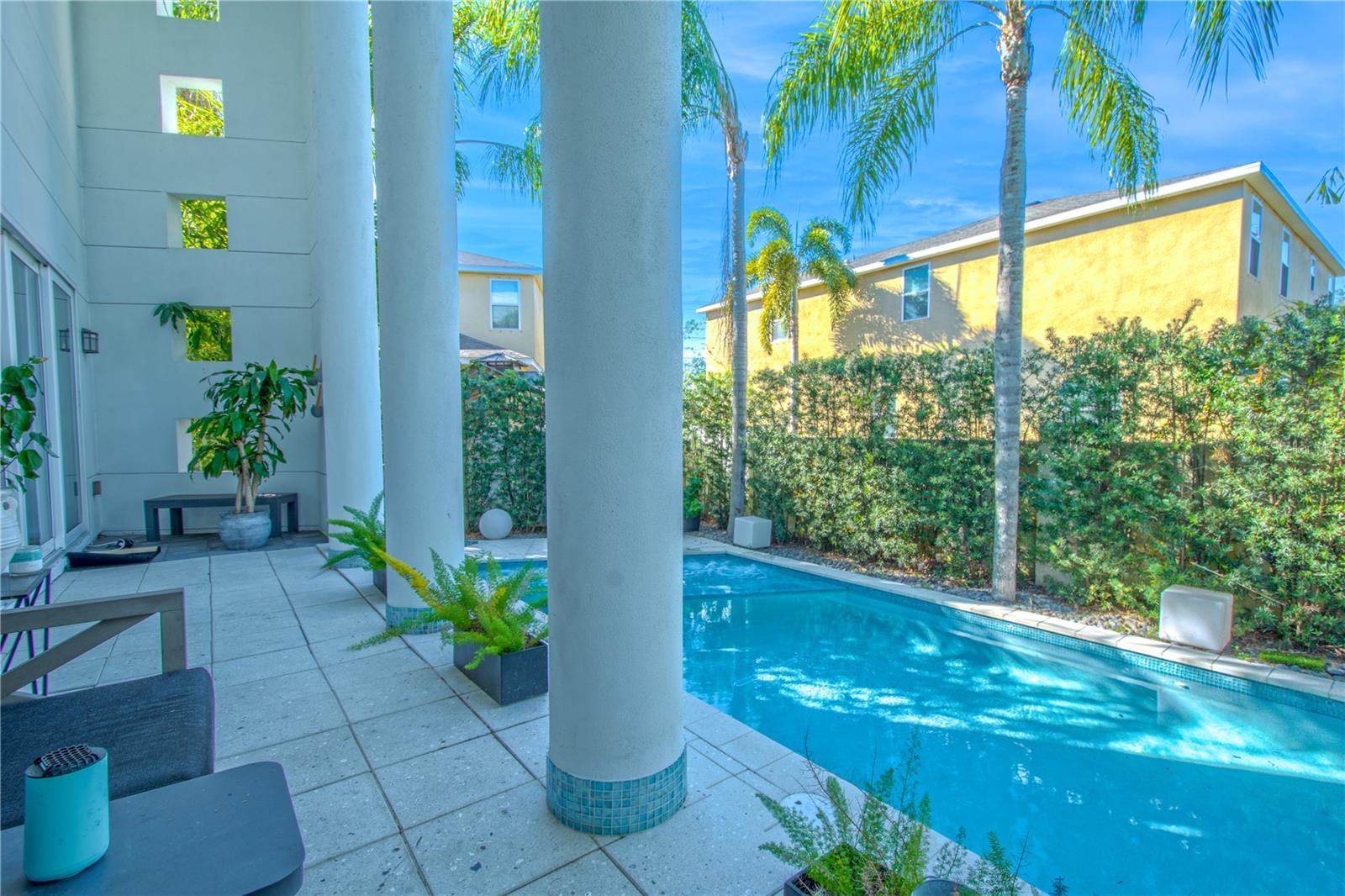 Majestic columns frame the patio, creating an elegant backdrop to the sparkling pool and spa.