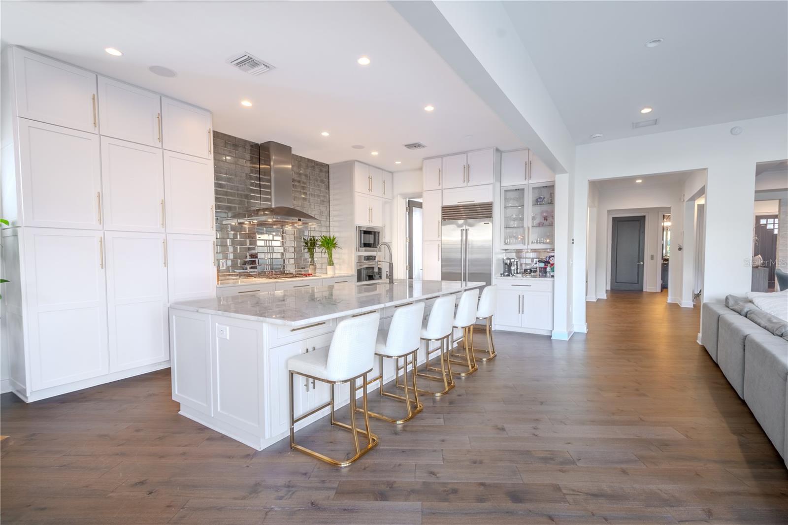 From the marble island to the Wolfe cooktop and Sub-Zero fridge, this kitchen is a blend of luxury and practicality.