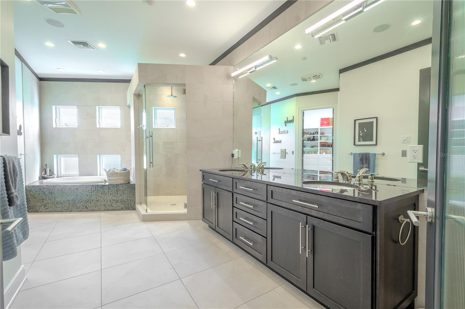 A dual-sink mirrored vanity and separate water closet with bidet add both style and functionality to this spa-like bathroom.