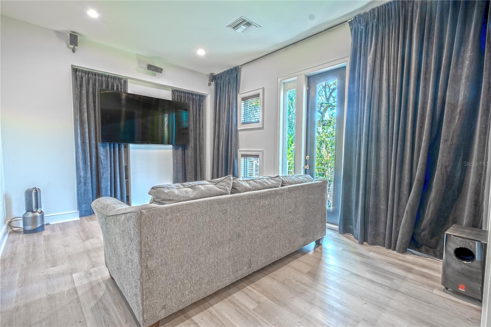 The 4th bedroom is currently used as a home theater with laminate flooring, recessed lighting, a walk-in closet and blackout drapes for the ultimate movie watching experience.