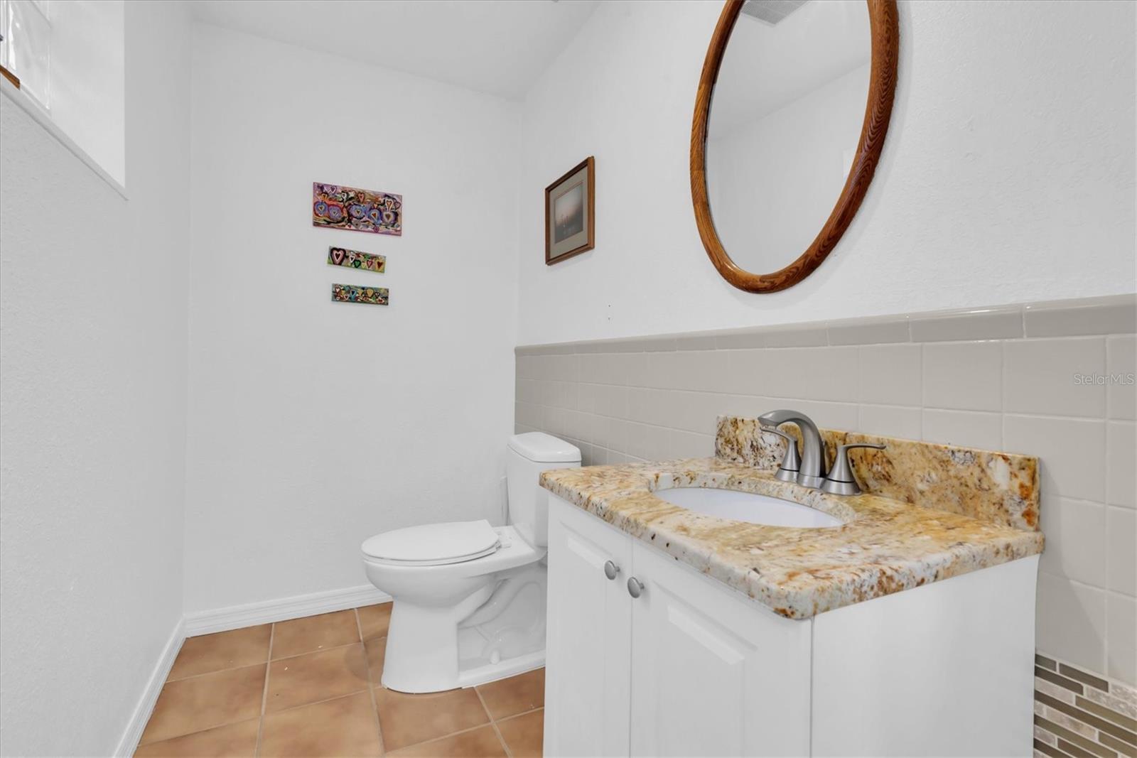 Recently renovated half bath with granite counter tops on the vanity.