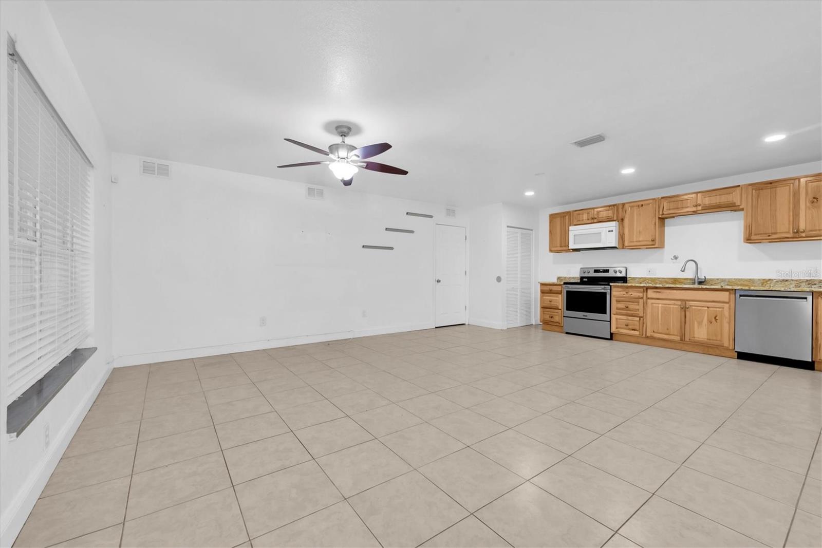 Great Room open concept living area looking at updated kitchen.