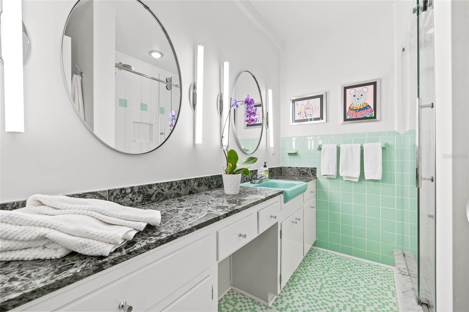 The bathroom has been updated with new fixtures and finishes. The vanity offers plenty of counter space and storage.