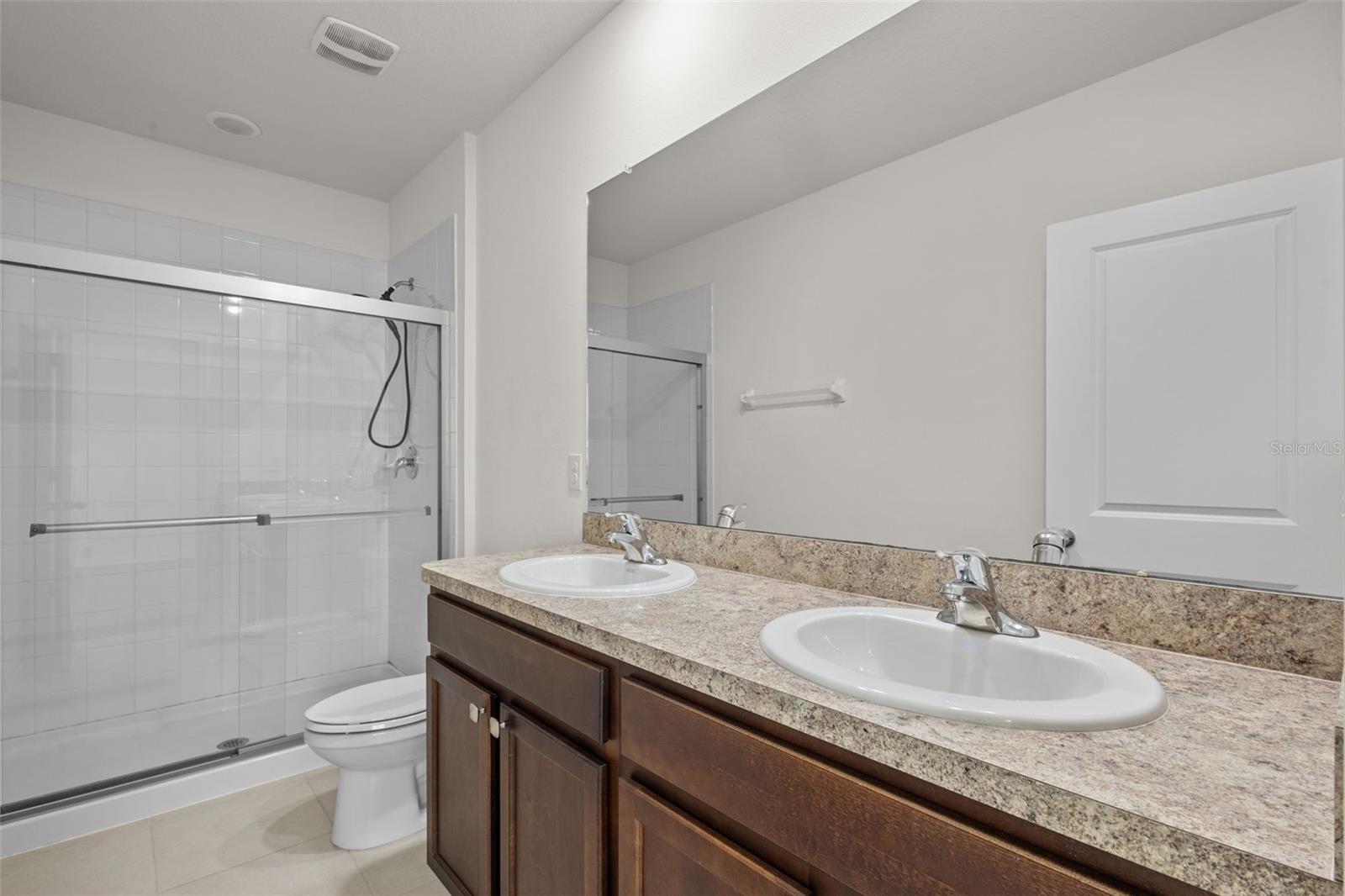 Primary En Suite Bathroom with double sinks and shower