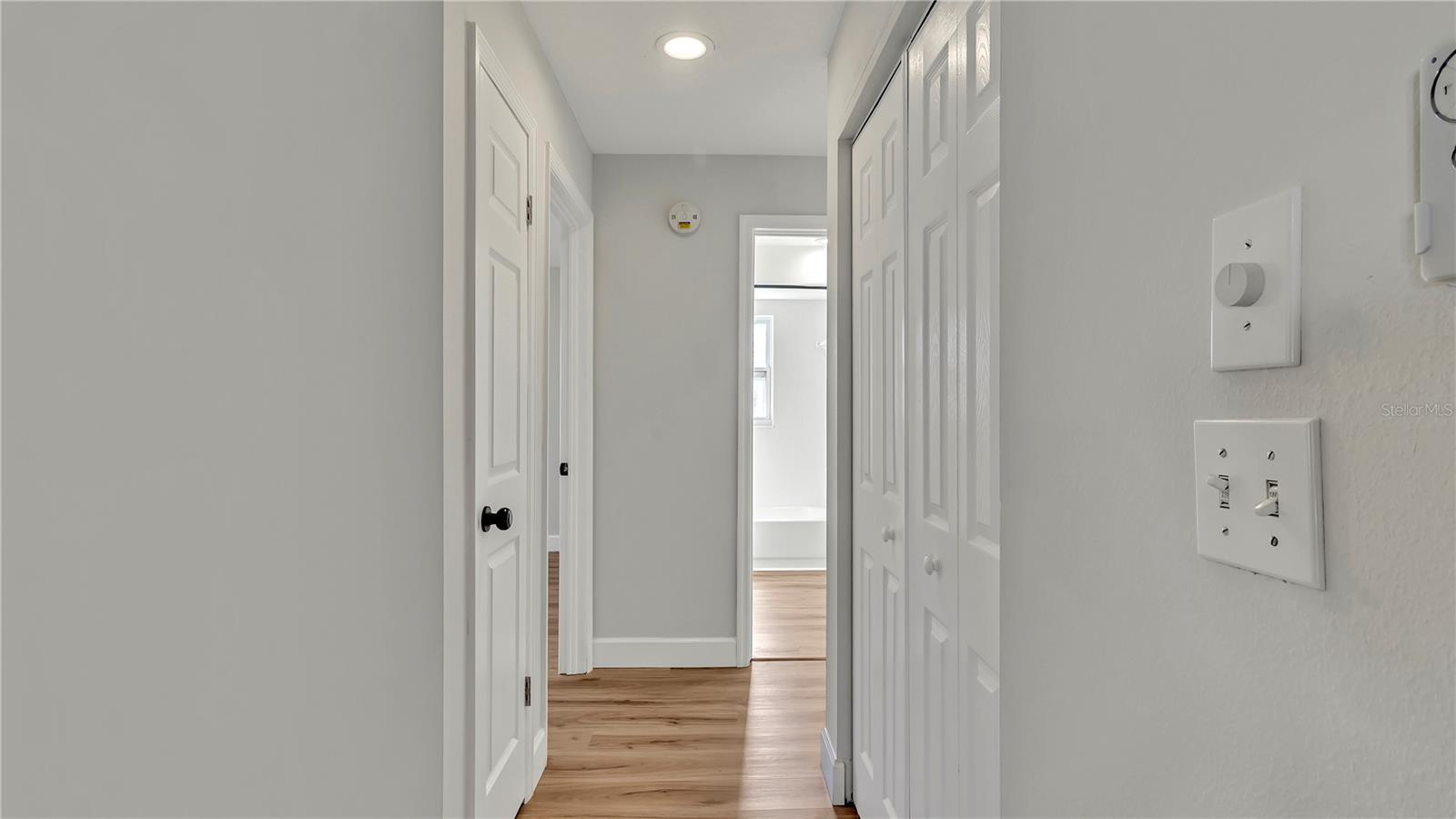 Hallway with 2 storage closets (leading towards bedrooms 2 & 3(