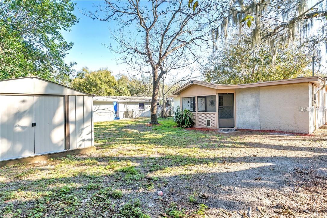 Huge fenced in yard with shed