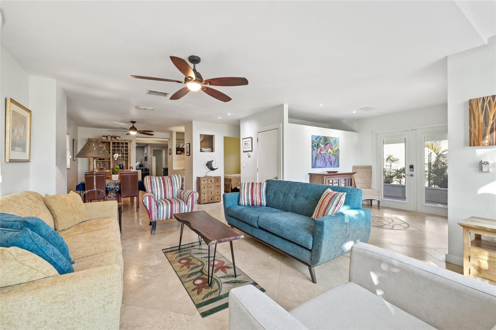 Polished travertine floors flow seamlessly throughout.