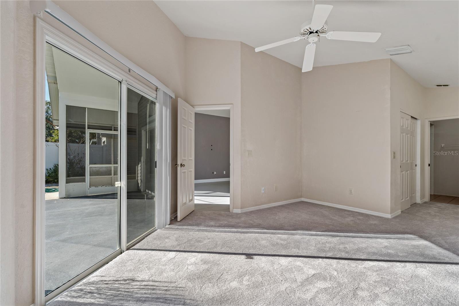 Primary Bedroom with Double Sliding Doors to Covered Lanai