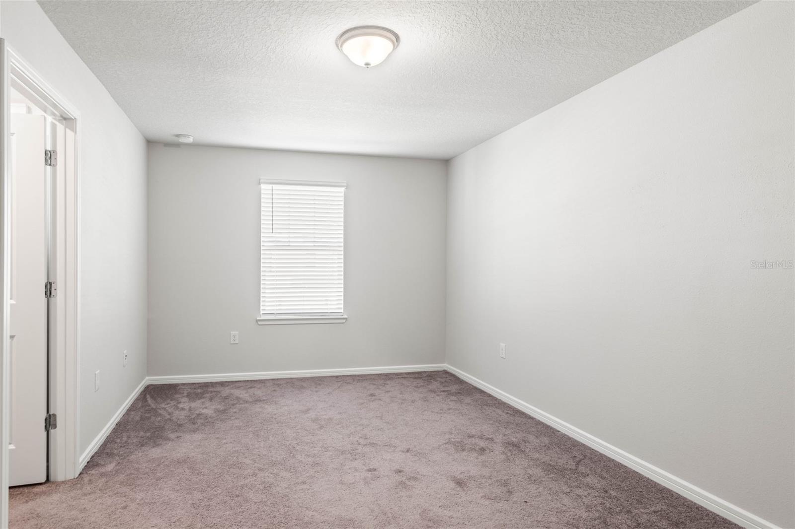 Bedroom 1 with a walk-in closet and ensuite bath.