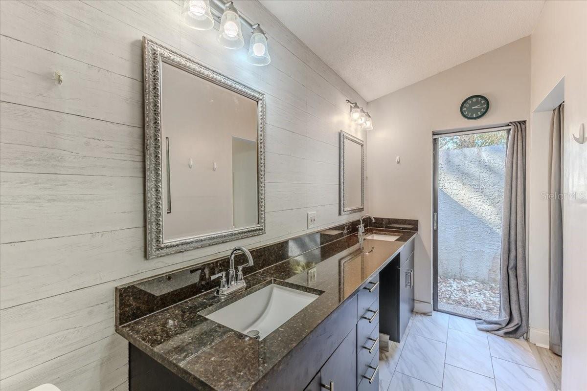 Dual Square Sink Vanity with Granite Counters & Plank Wall