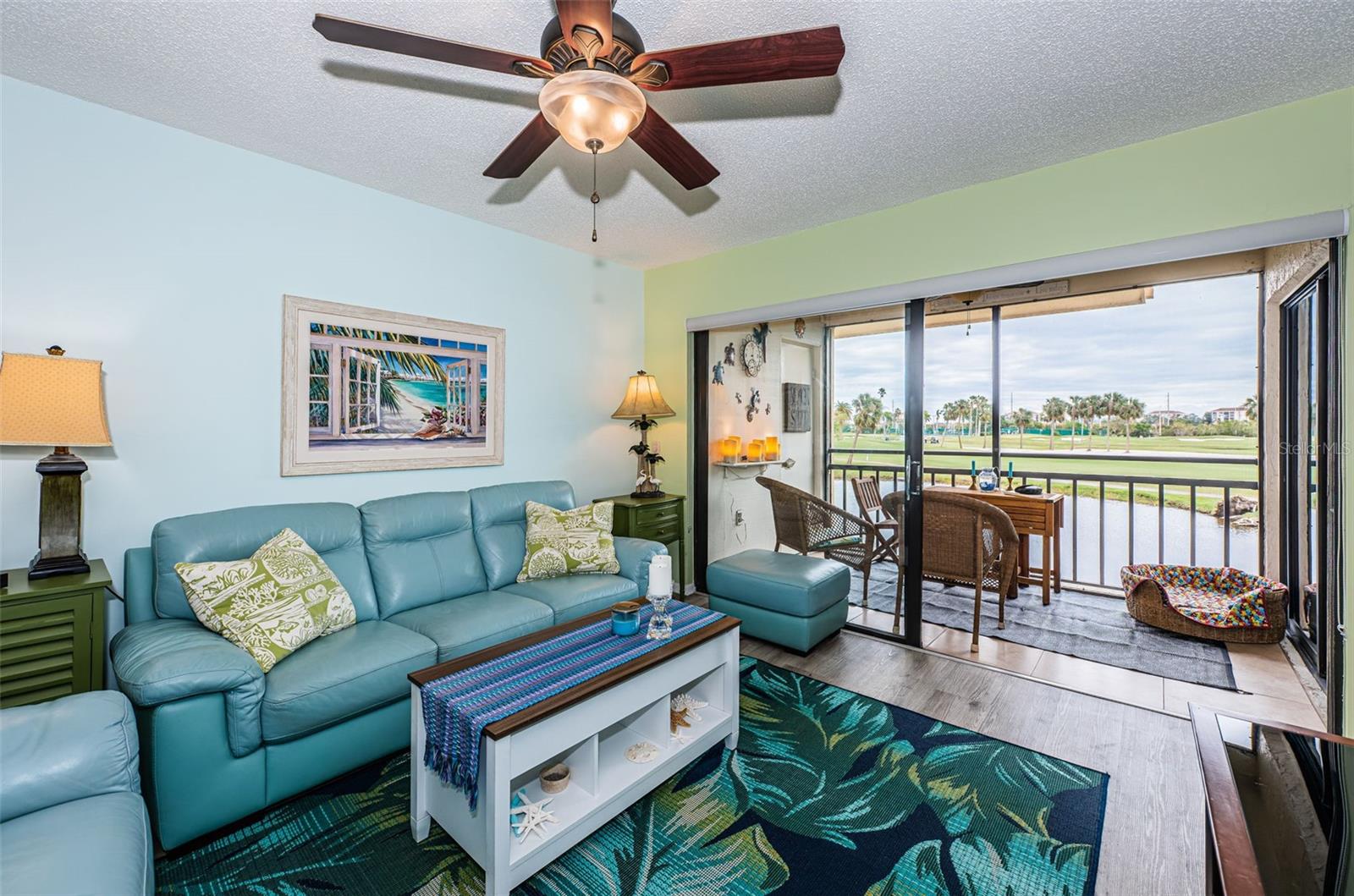 Living room looks out to the pond and golf course