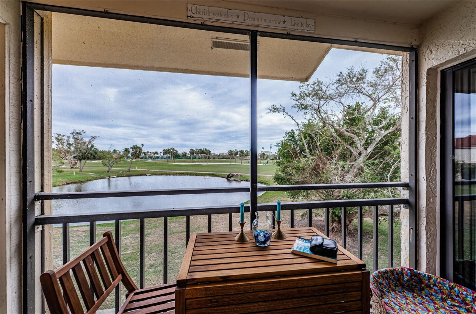 Screened rear balcony overlooks pond