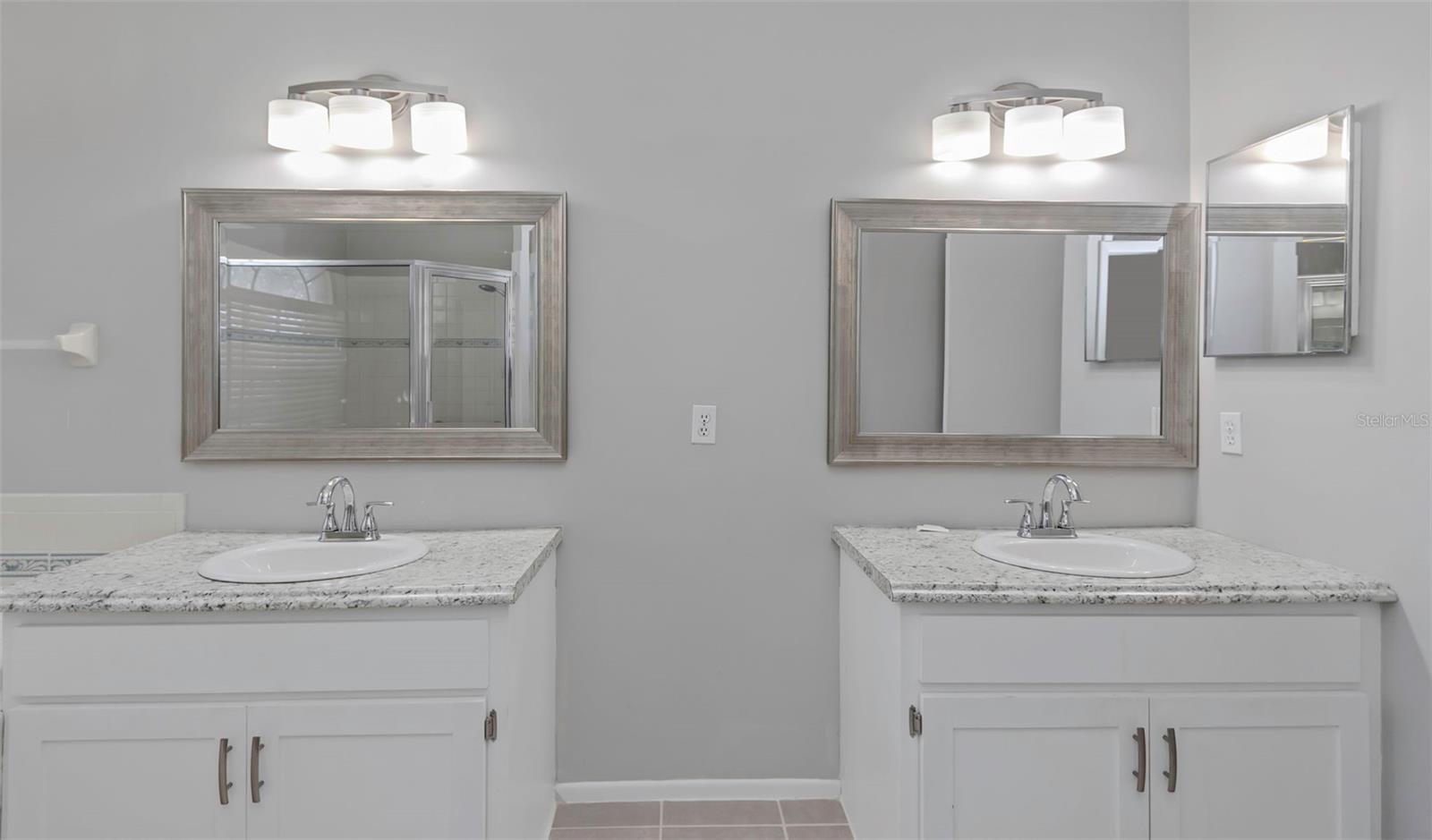 Dual vanities and separate enclosed water closet.