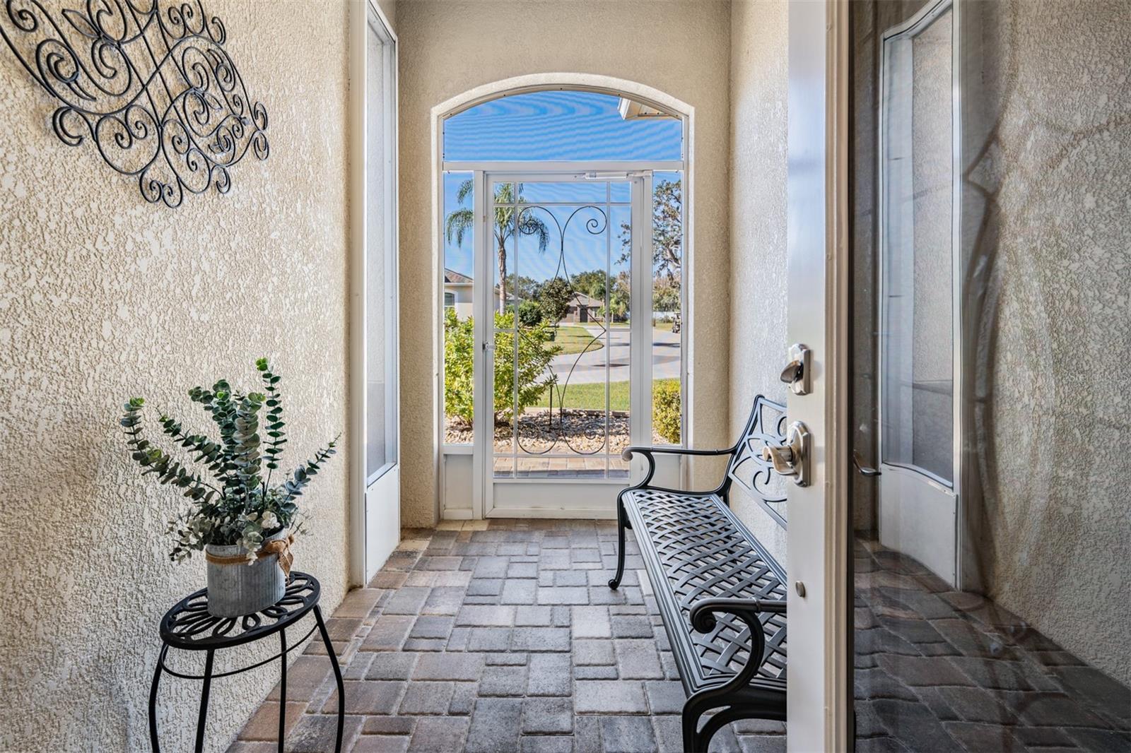 Arched, screened front entry welcomes you!