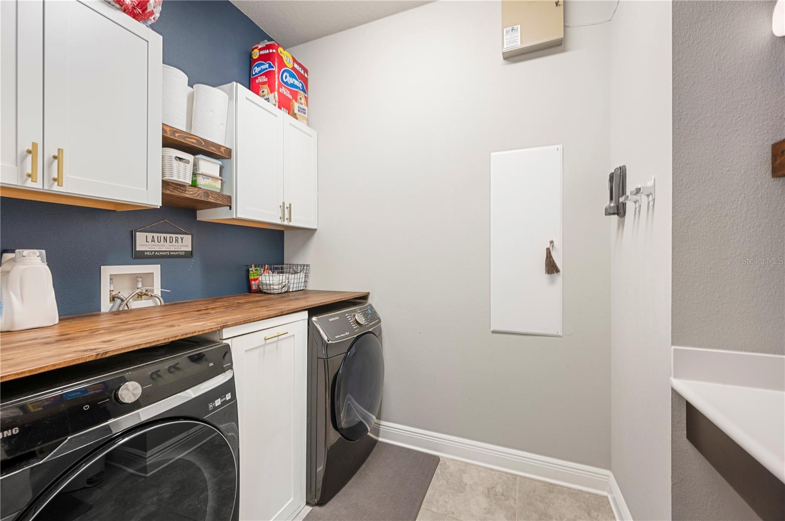 Functional Laundry Room with Folding table and Cabinets