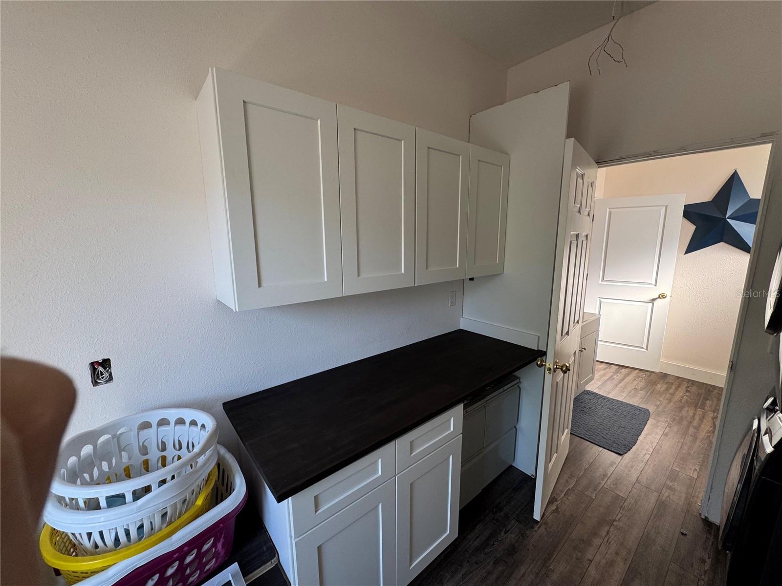 Huge laundry room with custom sink/cabinets!