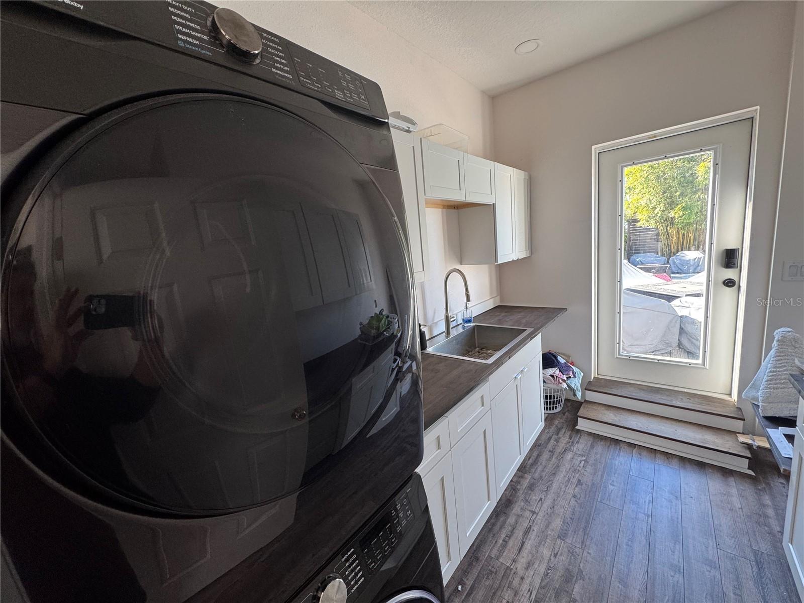 Huge laundry room with custom sink/cabinets!