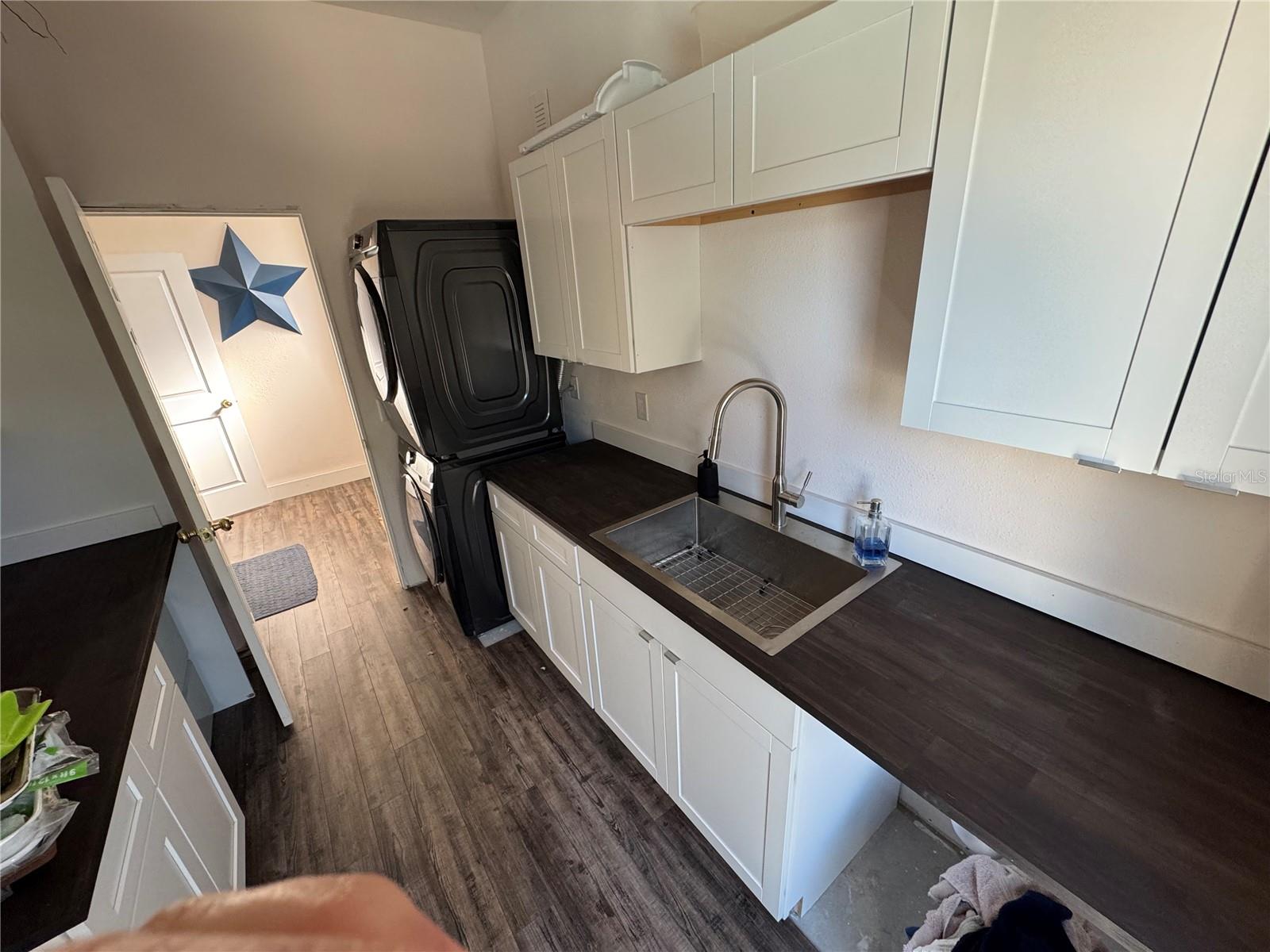 Huge laundry room with custom sink/cabinets!