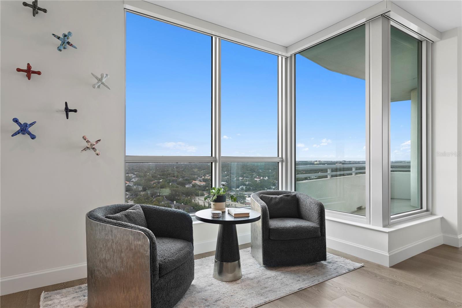 Moving beyond the kitchen, you enjoy a separate reading nook with floor to ceilings glass that blend seamlessly into living/great room and enjoys views extending to Old Tampa Bay!