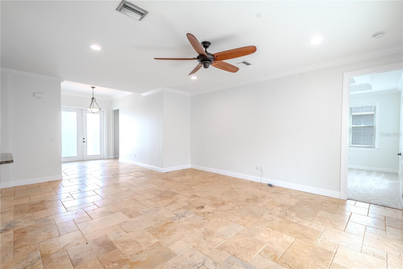 A view of the living room, foyer and entrance to the primary bedroom.