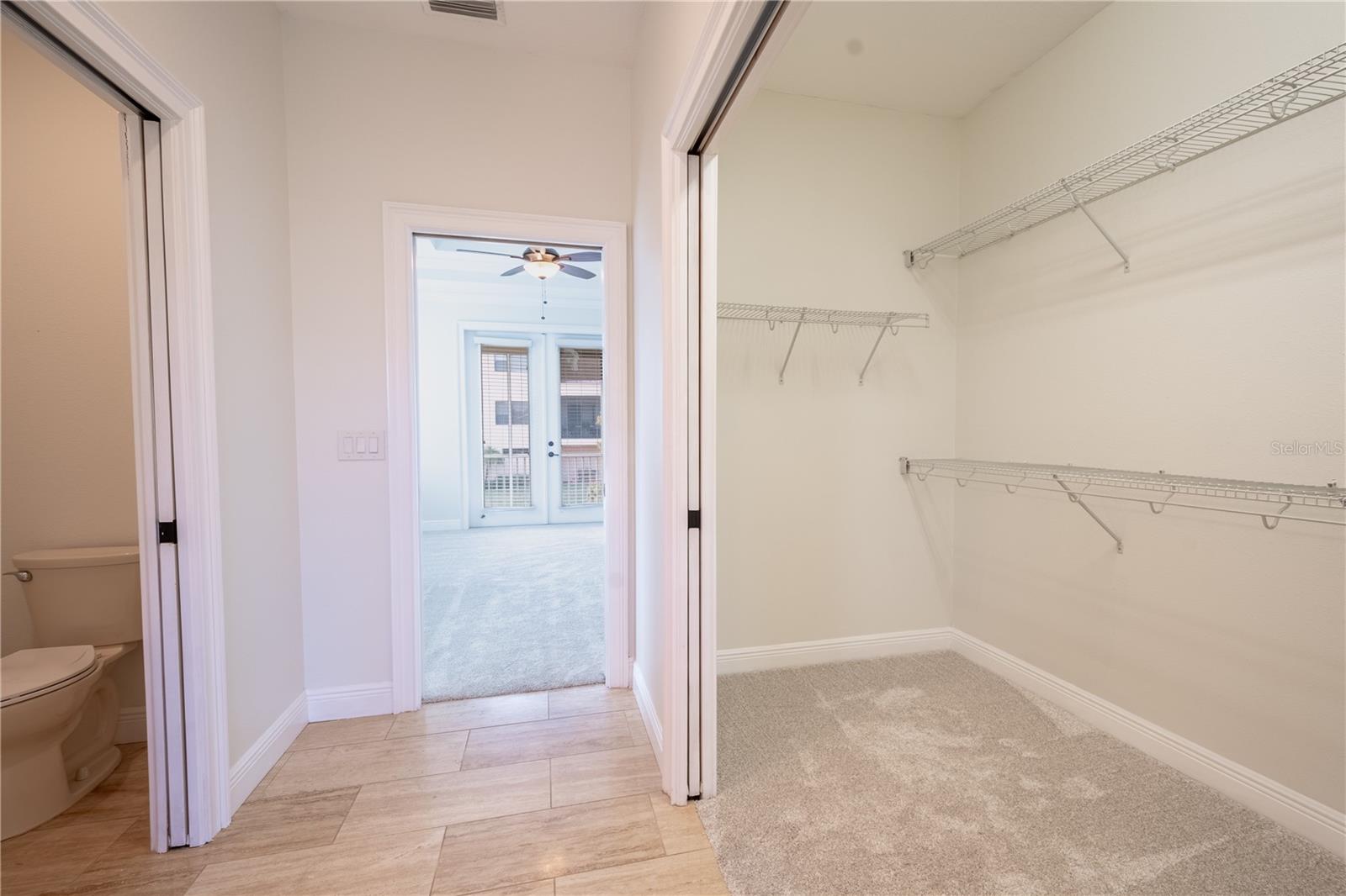 Primary ensuite walk-in closet and private water closet.