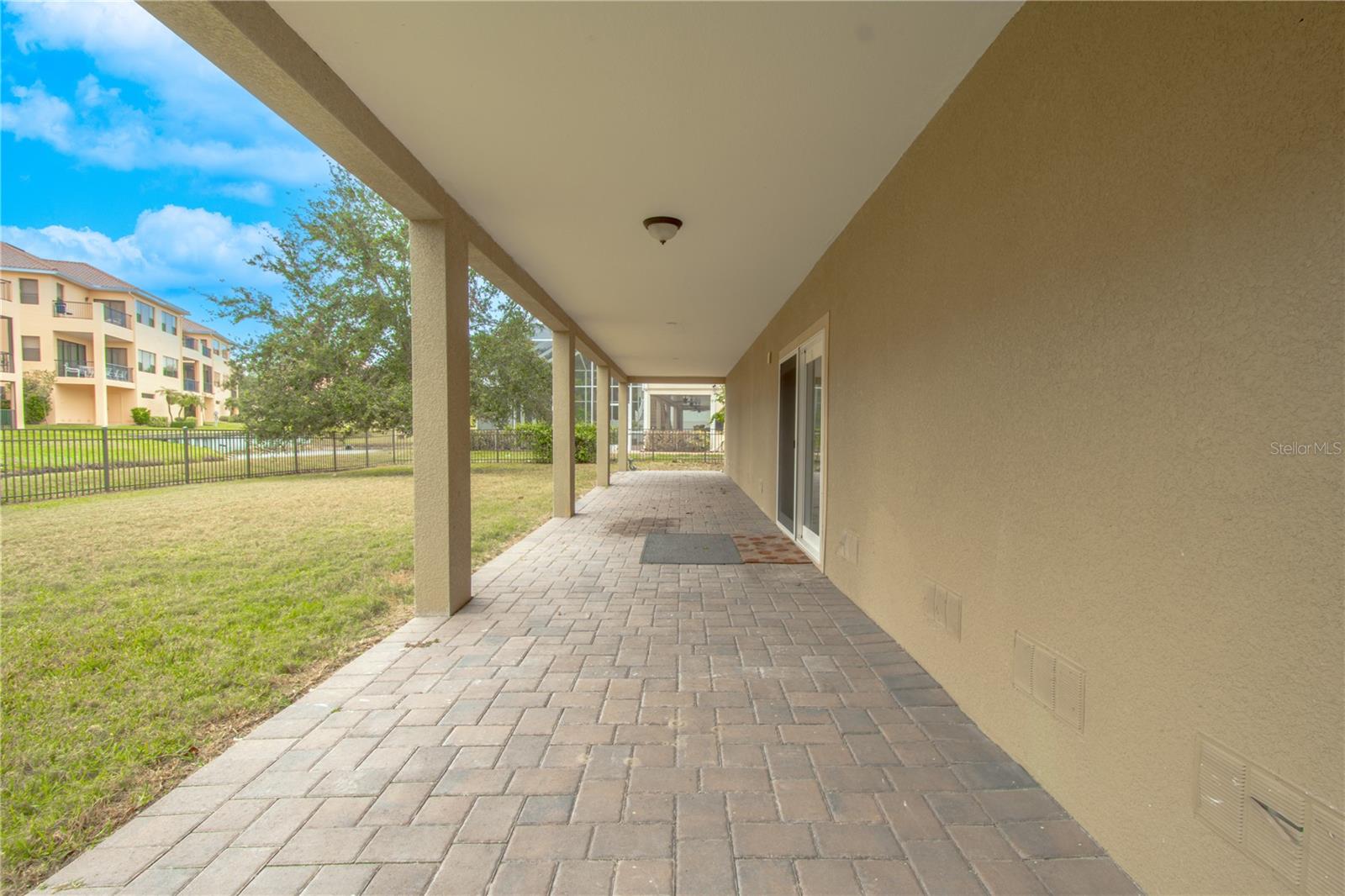 Ground floor has a cover stone paver patio that spans the width of the home.