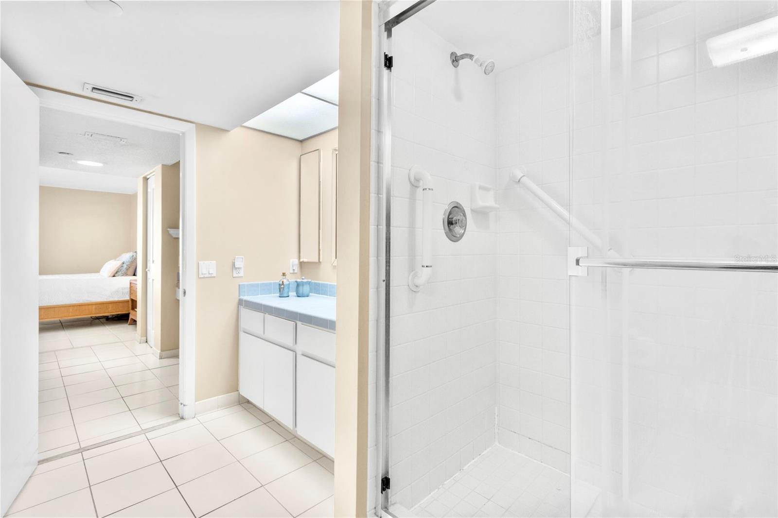 Primary bathroom features a large WALK in shower and a walk in tub, in a separate space.