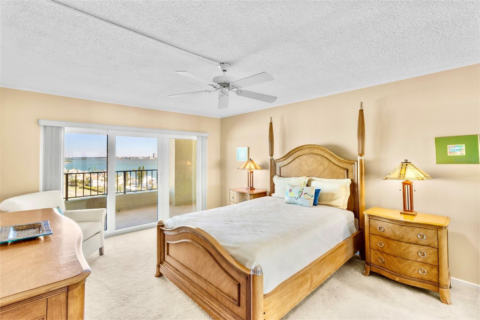 2nd of 3 Guest bedrooms with large linear closet and water views. This is the only carpeted bedroom in the condo as tile flooring is consistent throughout the other bedrooms and living areas in condo.