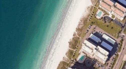 South Beach IV sits on the pale white beach sands and teal waters of the Gulf of Mexico