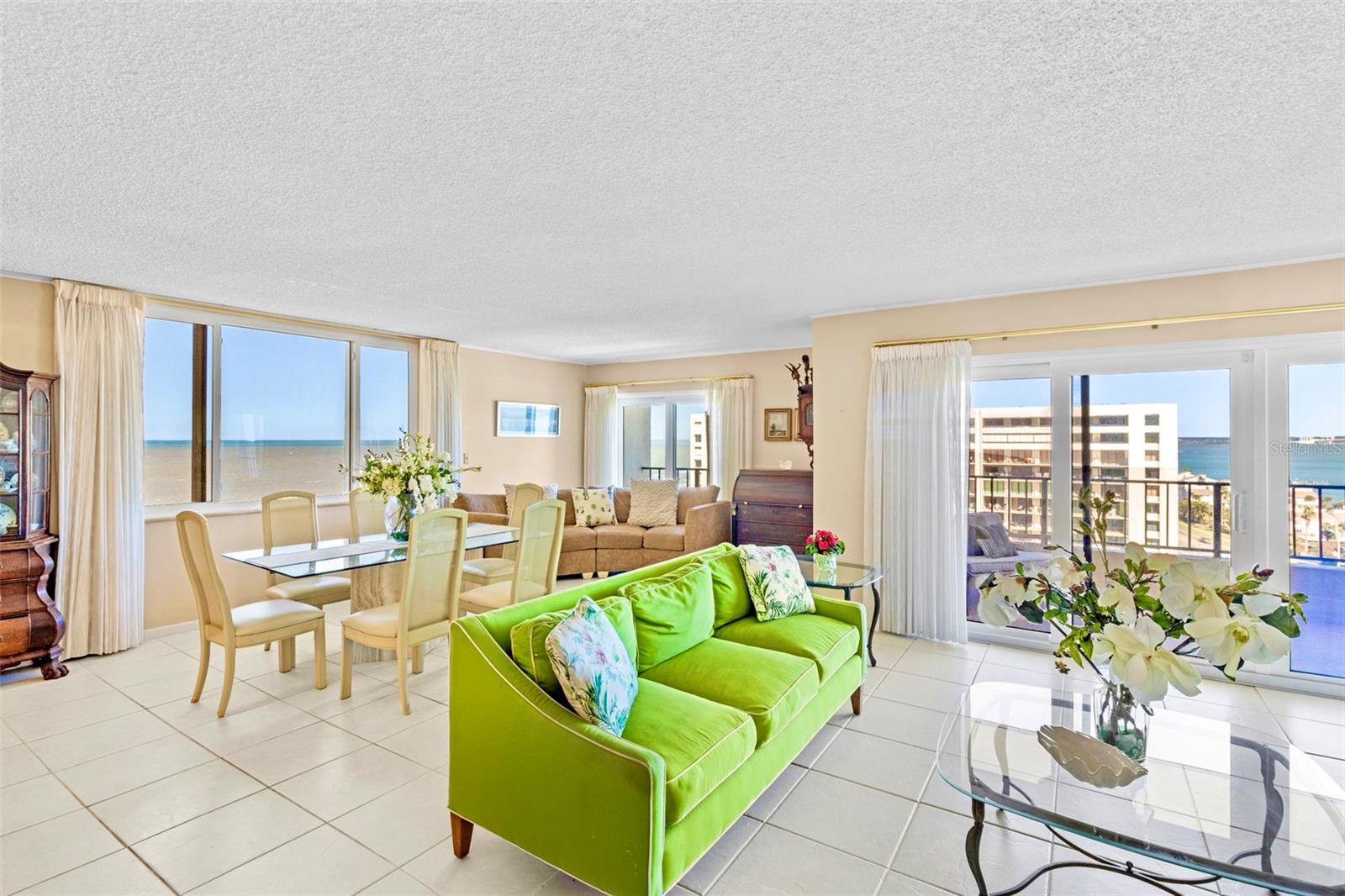 Living / dining area with Gulf Beach views AND in the evenings sparkling city views to the East over the Intracoastal Waterway