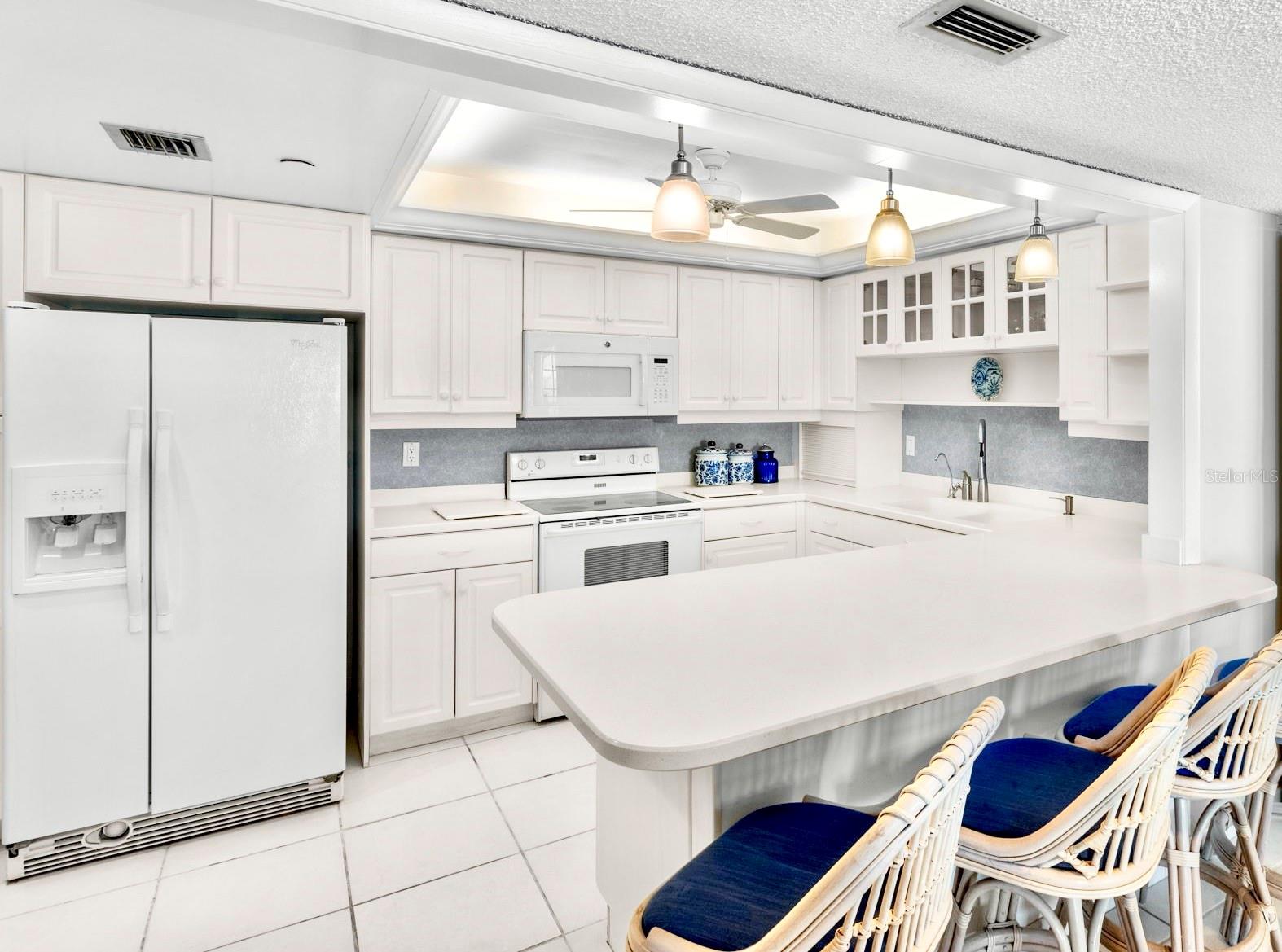 Kitchen offers loads of storage cabinetry.